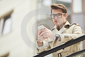 Businessman Using Smartphone Outdoors in Urban Setting
