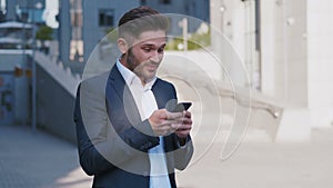 Businessman Using Smartphone and Reacting to Success. Handsome professional successful business man reaching personal