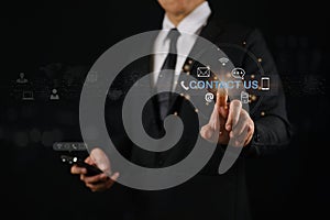 Businessman using smartphone and touching on virtual screen contact icons
