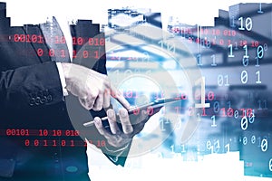 Businessman using tablet, binary numbers