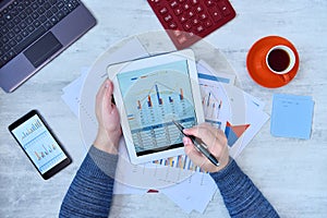 Businessman using tablet and checking stock market data