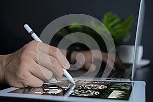 Businessman using tablet and checking stock market data