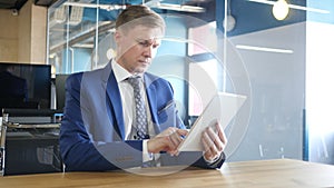 businessman using tablet computer touchscreen in office