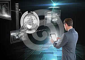 Businessman using tablet in a futuristic room and a world`s interface
