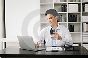 Businessman using tablet and laptop for doing math finance on an office desk, tax, report, accounting, statistics, and analytical