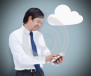 Businessman using a tablet pc with cloud computing symbol