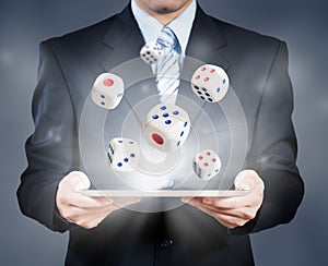 Businessman using tablet showing dice