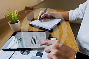 Businessman using tablet to the situation on the market value , Business concept