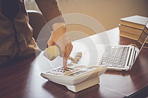 Businessman using telephone contact customer in office vintage tone