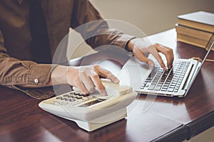 Businessman using telephone contact customer in office vintage tone