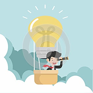 Businessman using a telescope with hot air balloon  in the sky concept