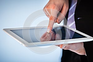 Businessman using touchscreen on tablet