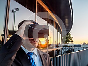 Businessman using virtual reality glasses in a business center