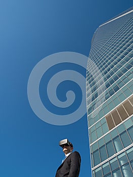 Businessman using virtual reality glasses in a business center