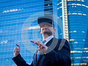 Businessman using virtual reality glasses in a business center a