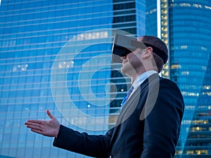 Businessman using virtual reality glasses for a meeting in cyberspace.