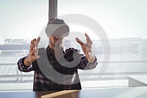 Businessman using virtual reality headset in creative office