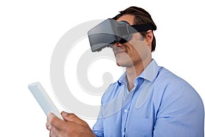 Businessman using vr glasses while holding tablet computer
