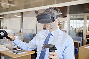 Businessman using VR technology in an office, close up