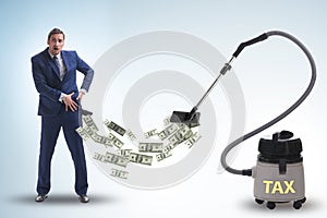 Businessman and vacuum cleaner sucking money out of him