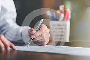 Businessman validates and manages business documents and agreements, signing a business contract approval of contract documents