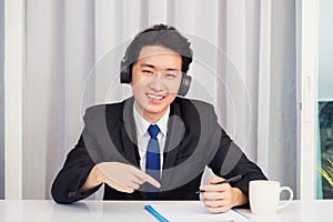 Businessman video conference call and write notebook information