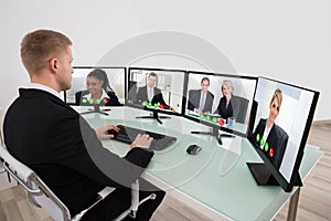 Businessman Video Conferencing On Desk