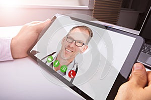 Businessman Video Conferencing With Doctor