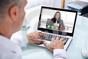 Businessman Videoconferencing With Colleague On Laptop