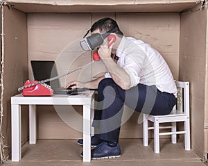 Businessman with virtual reality glasses talking on the phone