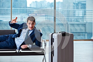 Businessman waiting at the airport for his plane in business cla