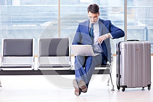 Businessman waiting at the airport for his plane in business cla