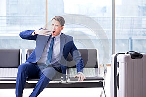 Businessman waiting at the airport for his plane in business cla