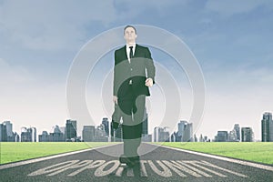 Businessman walking above opportunity word on the road