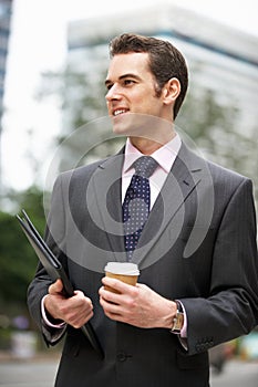 Businessman Walking Along Street