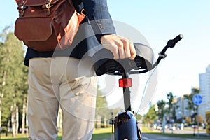 Businessman walking with bike in street after work.