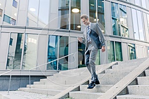 Businessman walking downstairs in an office park