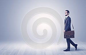 Businessman walking in front of an empty wall