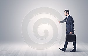 Businessman walking in front of an empty wall