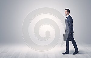 Businessman walking in front of an empty wall