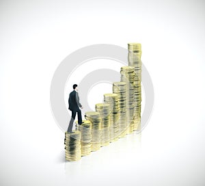 Businessman walking on gold coins