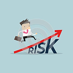 Businessman walking on grow up stock market graph above the word Risk.