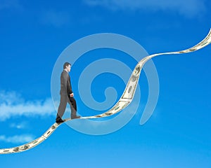 Businessman walking on growing money trend with blue sky background