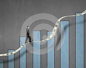 Businessman walking on growth money trend with chart