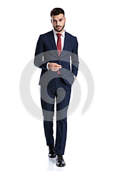 Businessman walking with hand in pocket and attitude