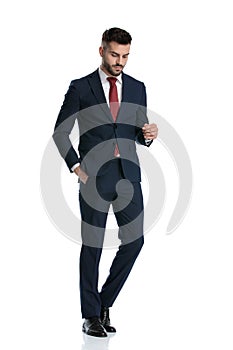 Businessman walking with hand in pocket and looking down