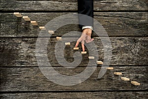 Businessman walking his fingers up steps