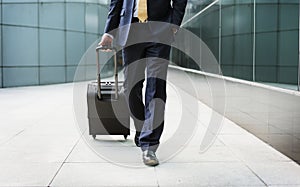 Businessman walking with his luggage