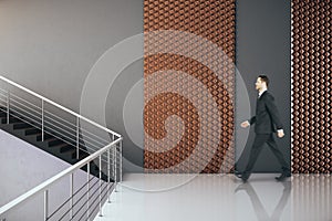 Businessman walking in modern hall interior