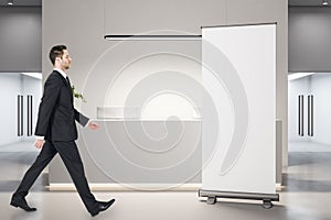 Businessman walking in modern office lobby interior